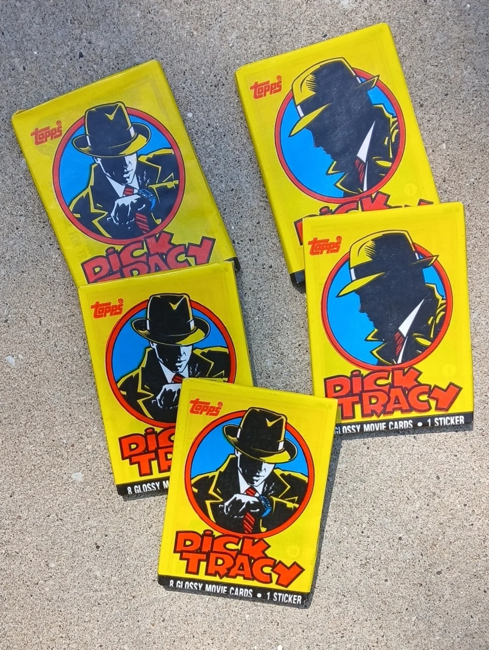 five unopened packs of 1990 Topps Dick Tracy movie trading cards.